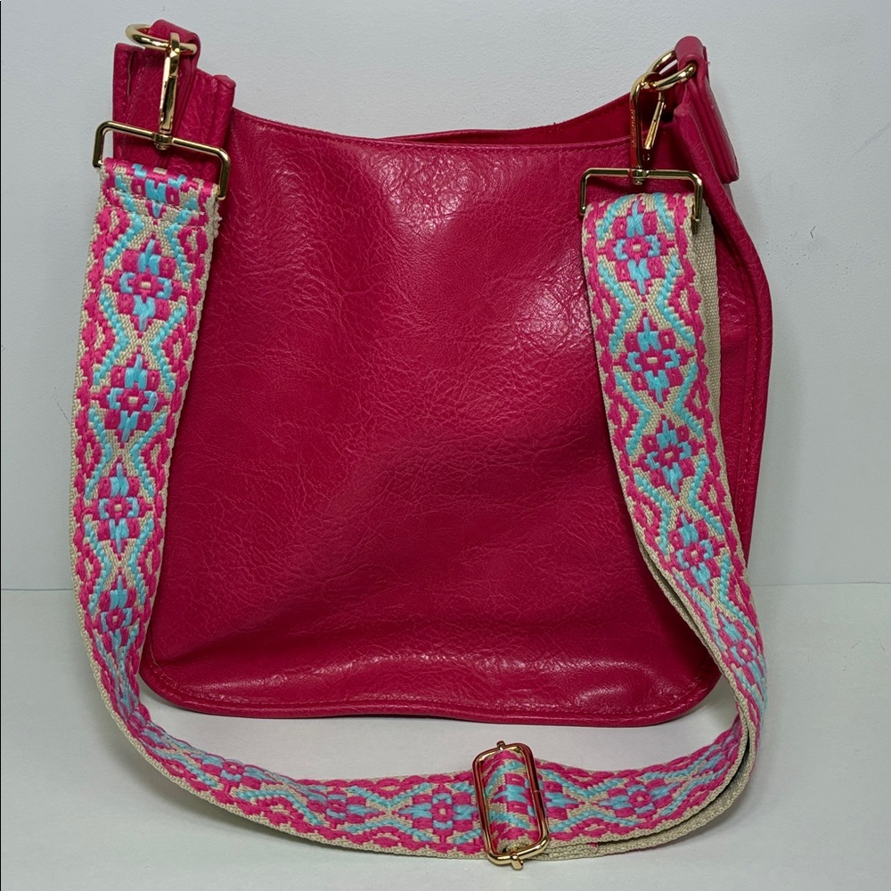 Ahdorned classic vegan leather messenger tote.